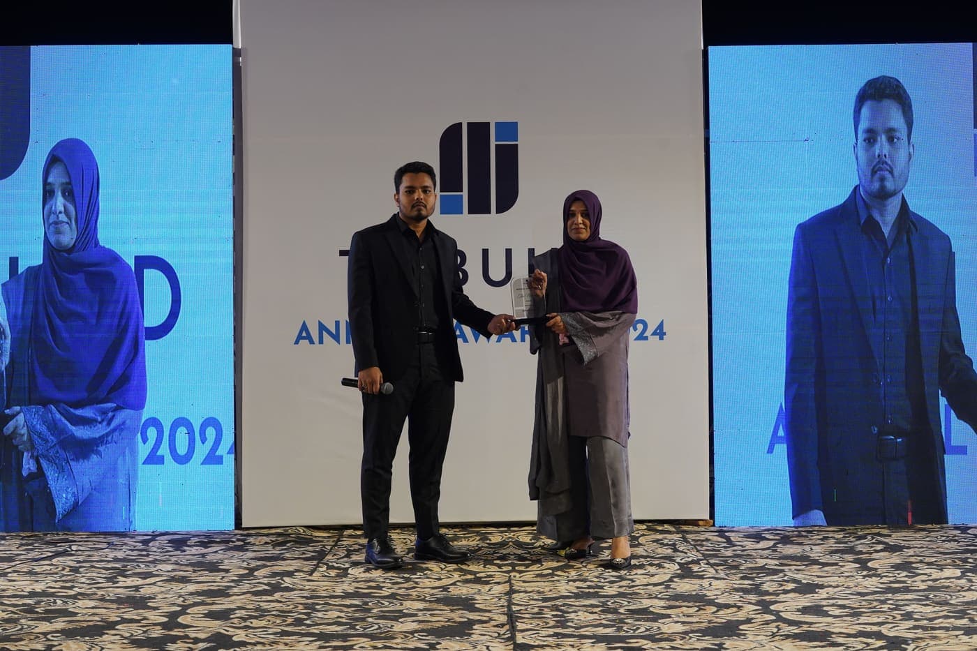 A colleague receiving her award on stage at the Tribuild Annual Awards 2024