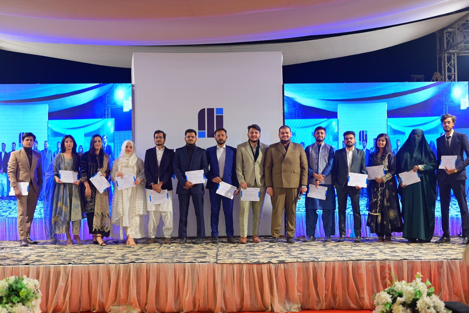 Colleagues on stage holding their certificates at the Tribuild Annual Awards